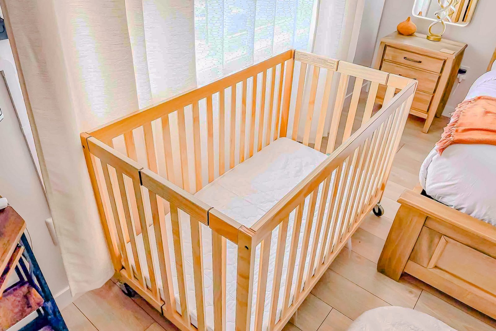 Wooden baby crib set up in a bedroom at Starz at Night luxury suite in Lantz, Nova Scotia