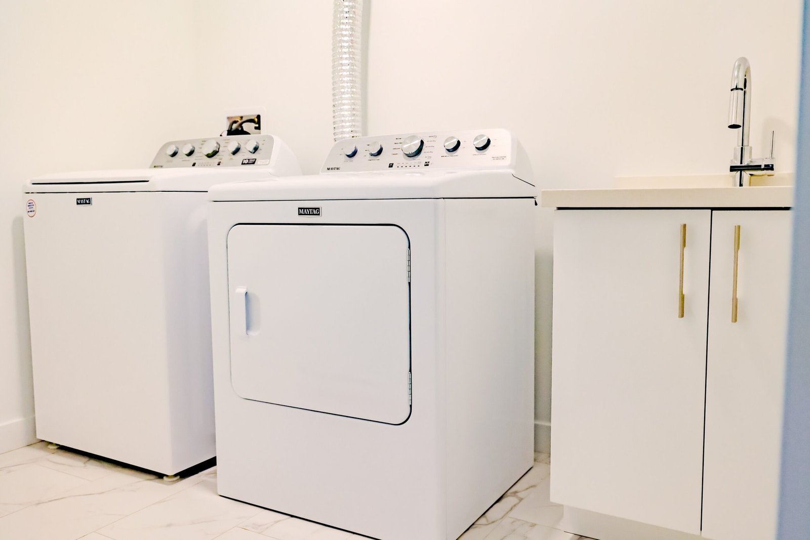 Maytag washer and dryer in the private laundry room at Starz at Night luxury suite