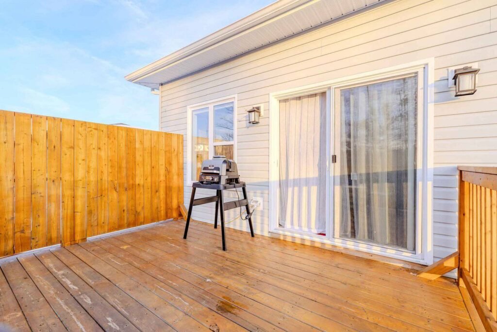 Outdoor deck patio with premium grill and sliding glass door access at Starz at Night Luxury Suite