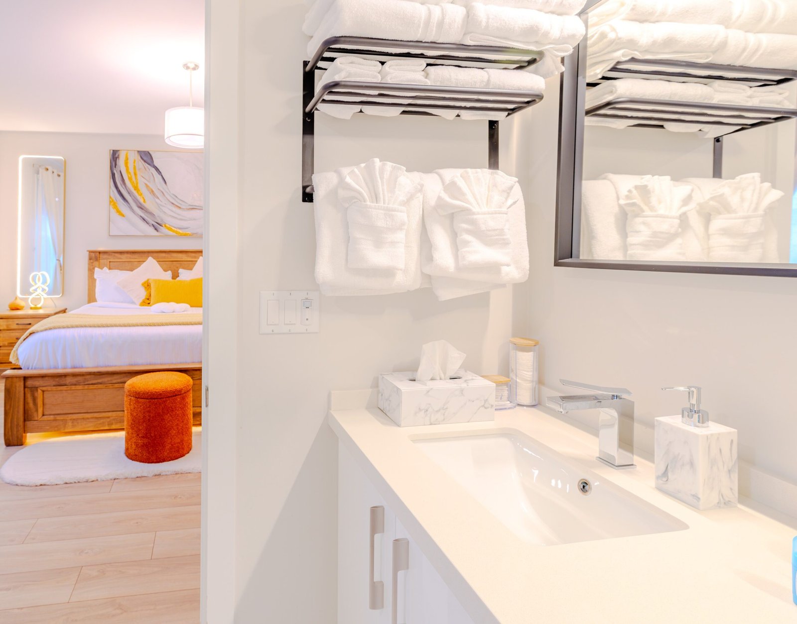 Bathroom vanity with folded plush towels and marble accents at Starz at Night luxury suite in Lantz, Nova Scotia