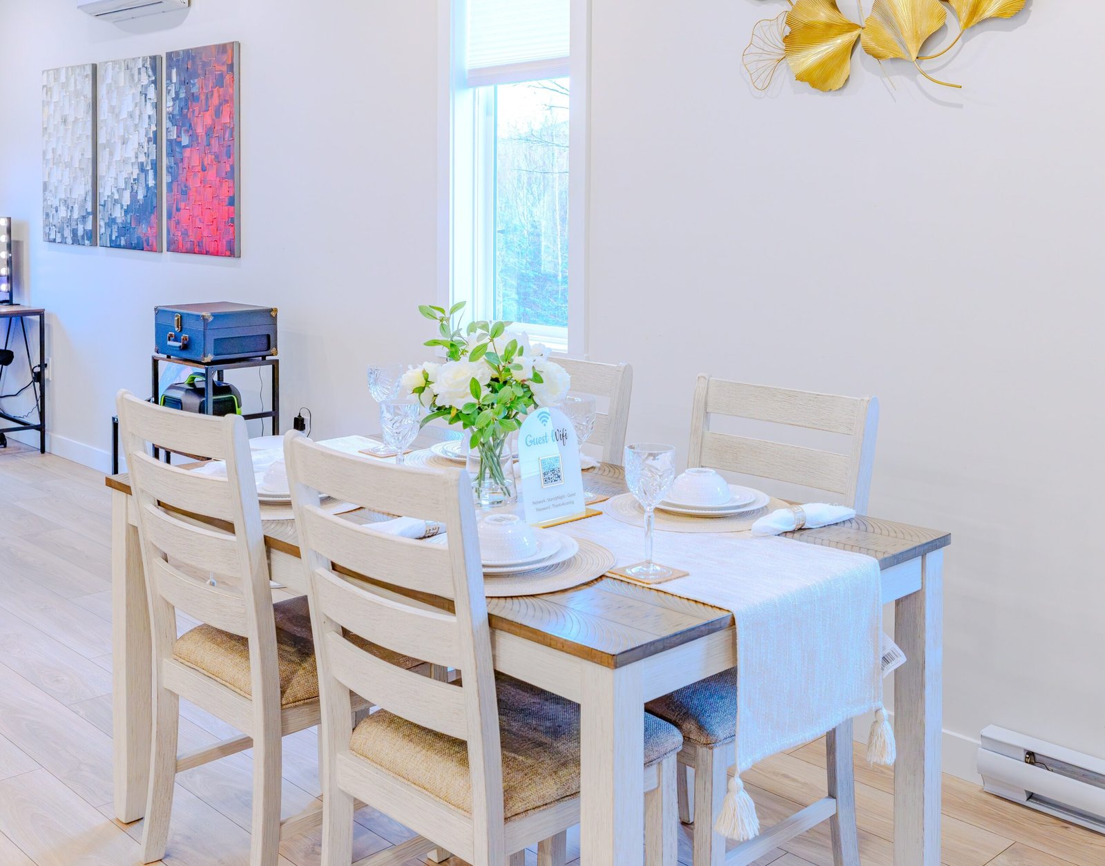 Elegant dining table set for six with fresh flowers at Starz at Night luxury suite in Lantz, Nova Scotia