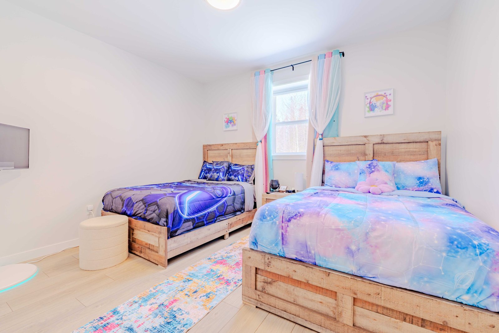 Kids bedroom with gaming-themed and galaxy-themed queen beds at Starz at Night luxury suite in Lantz, Nova Scotia